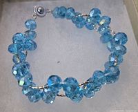 Overall view of blue aqua crystal multi-strand bracelet showing beads and clasp
