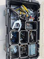 Open toolbox showing compartments, hand tools and hardware