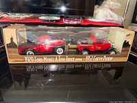Box front showing both red die-cast vehicles and product labeling