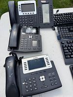 Five VoIP phones grouped on table
