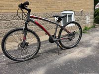 Full left side view of Reebok mountain bike showing frame, wheels and components
