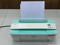 Front view showing HP DeskJet 3755 with paper in input tray