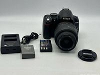 Complete set: camera with lens, charger, batteries, cable, lens cap