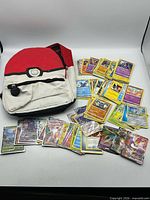 Backpack and spread of Pokémon cards displayed