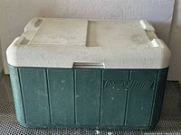 Front view of green Coleman cooler with white lid