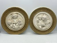 Pair of round cherub plaques front view