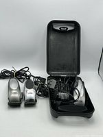 Overview of three Wahl clippers, cords, guards and case