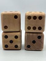 Front view of four large wood dice stacked
