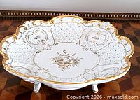 Top view showing entire bowl, floral center, pierced lattice, gilt rim