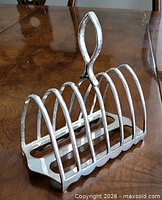 Full view of toast rack angled, showing arches, handle, base detail