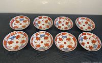All eight Imari porcelain saucers laid out face up