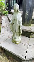 Front view showing full statue and facial damage