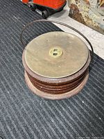 Overall view of round foot warmer showing lid, wooden body and handle