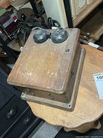 angled view of wooden ringer box showing twin bells and overall form
