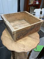 Top angled view of wooden crate showing interior and printed exterior text