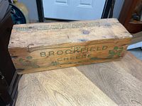 overall view of Brookfield Cheese wood crate showing printed branding and wear