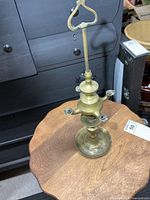 Full view of brass oil lamp showing height, base, burners, and finial