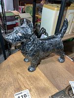 front side of cast iron Scottie dog door stop on table