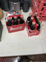 Both six-pack carriers with sealed bottles on tabletop