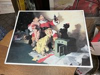 Full view of metal Coca-Cola Santa sign on table