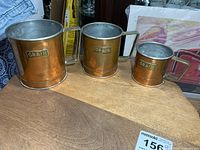 Front view of all three graduated grain measures
