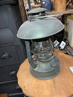 Front view of Dietz Air Pilot lantern on table
