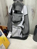 Front view of Dunlop wheeled backpack with zip compartments visible