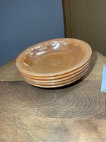 Side view showing stack of 5 peach lustre bowls