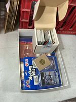 Open box showing cards, Hockey Puk pack, coin, booklets