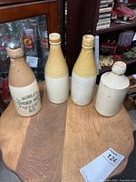 Group view of all four stoneware bottles on table