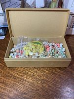 Open box showing assorted bead jewelry pieces