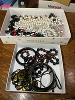 Two boxes filled with assorted necklaces, bangles and bracelets