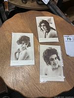 Three postcards laid out on wooden surface