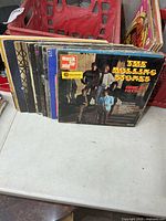 Stack of LPs showing The Rolling Stones Great Hits front cover with additional sleeves behind