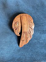 Front view showing carved eagle design, eye inlay, overall shape