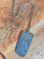 Front view of pewter cat pendant on chain