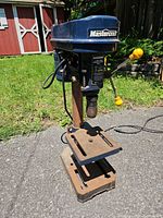 Front view of Mastercraft benchtop drill press showing overall form, cast-iron table and base