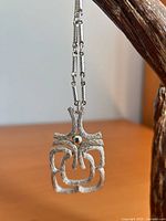Pendant hanging to show design and chain detail