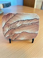 Front view of sandstone slab on easel showing banded pattern