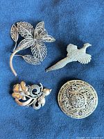 Front view of all four brooches