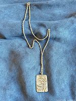 Full view of necklace showing chain and rectangular pendant