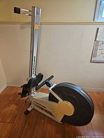 Side view showing full rower, fan flywheel, seat, handle, branding