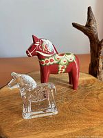 Both Dala horse figurines on wood surface
