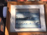 Framed ocean photograph showing a wave scene, signed by Blaise Hayward, with a wooden frame and matting. Photo taken to show the signed photograph item.