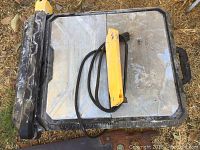 Wet tile saw, showing yellow and black handle with metal cutting surface