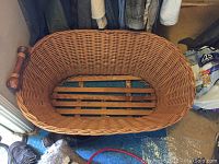 Wicker laundry basket with wood handles shown from top view