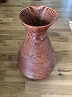 Full view of tapered woven rattan floor vase