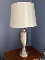 Full view of lamp on table showing shade and base