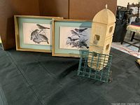 Overall lot showing two framed bird prints, cedar feeder, green suet cage