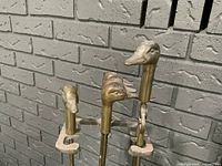 Close-up of three brass duck head handles